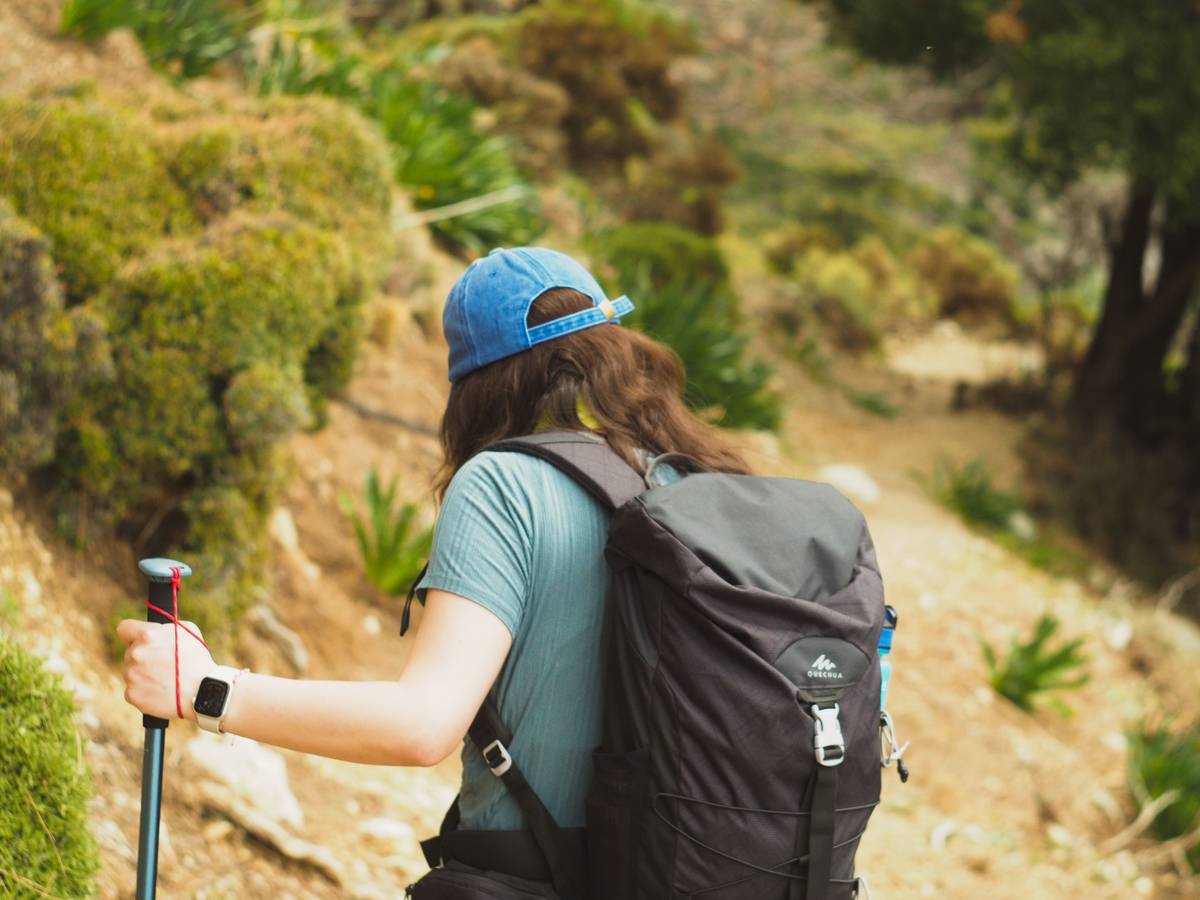altimeter watch for backpacking displaying accurate elevation reading beside topographic map and compass on rocky trail